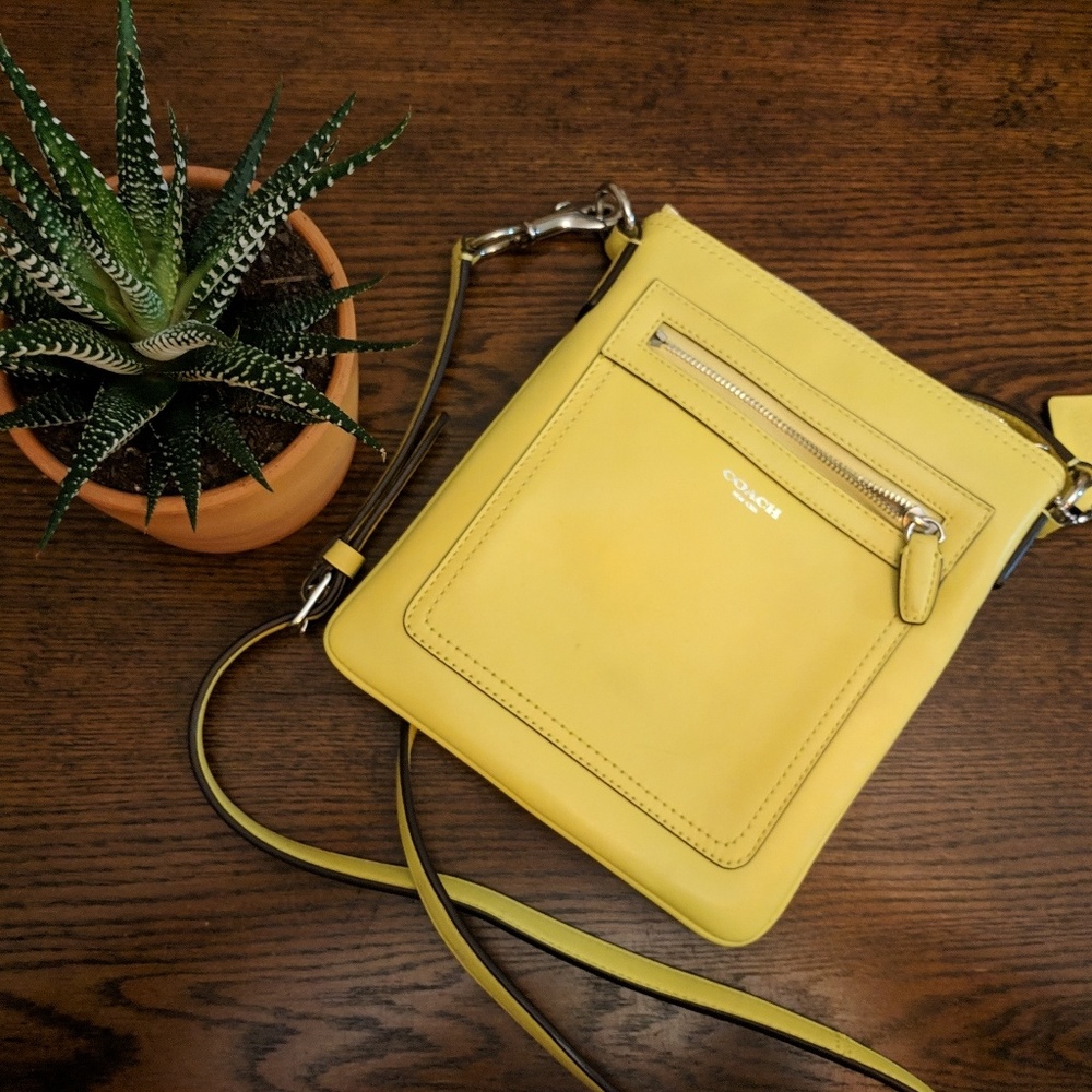 Pale yellow Coach crossbody purse